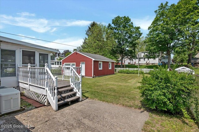 327 Sullivan Rd, Schenectady, NY 12304 - view of yard with an outbuilding, a wooden deck, and a sunroom