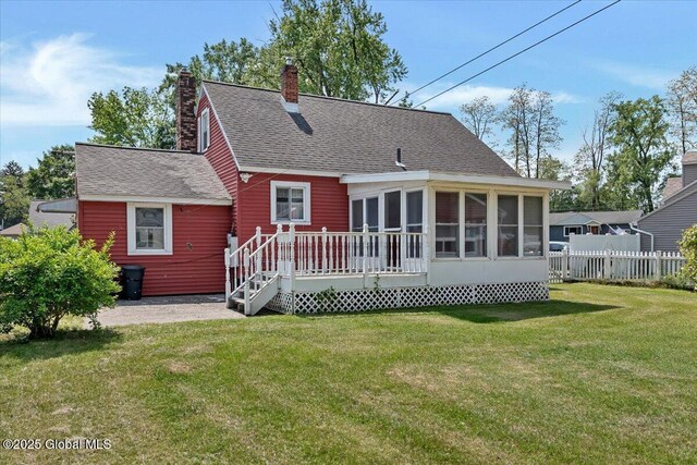 327 Sullivan Rd, Schenectady, NY 12304 - rear view of property with a shingled roof, a sunroom, and a chimney