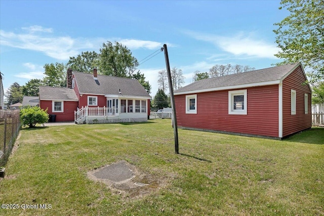 327 Sullivan Rd, Schenectady, NY 12304 - rear view of house featuring a deck, a chimney, and an outdoor structure