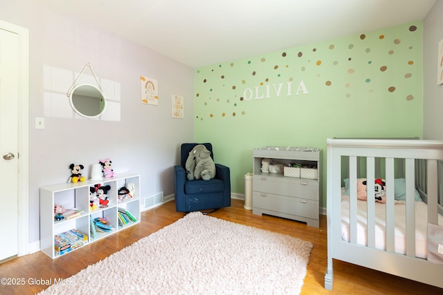 1269 Hawthorn Rd, Niskayuna, NY 12309 - bedroom with a nursery area and wood finished floors