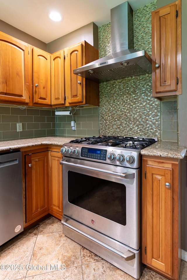 1269 Hawthorn Rd, Niskayuna, NY 12309 - kitchen with appliances with stainless steel finishes, wall chimney range hood, decorative backsplash, and brown cabinets