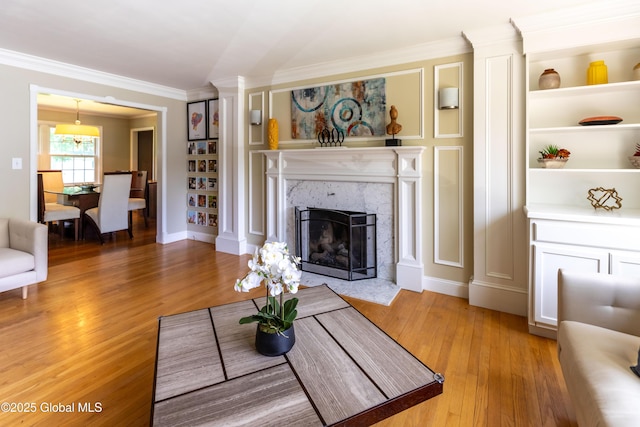 1269 Hawthorn Rd, Niskayuna, NY 12309 - living room featuring crown molding, light wood-type flooring, and a premium fireplace