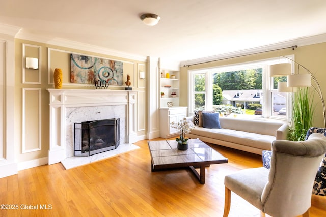1269 Hawthorn Rd, Niskayuna, NY 12309 - living room featuring ornamental molding, wood finished floors, a high end fireplace, and built in shelves