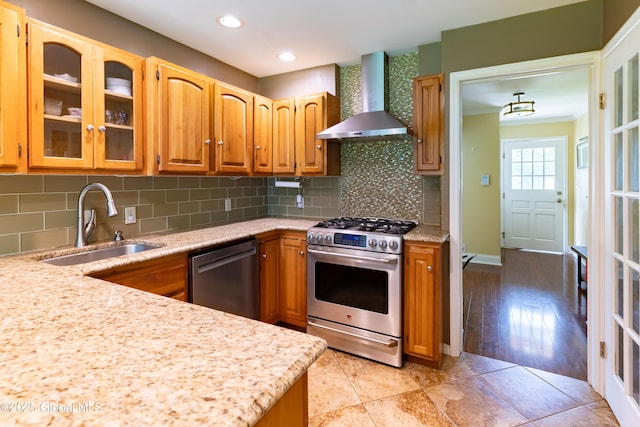 1269 Hawthorn Rd, Niskayuna, NY 12309 - kitchen featuring wall chimney range hood, appliances with stainless steel finishes, glass insert cabinets, tasteful backsplash, and ornamental molding