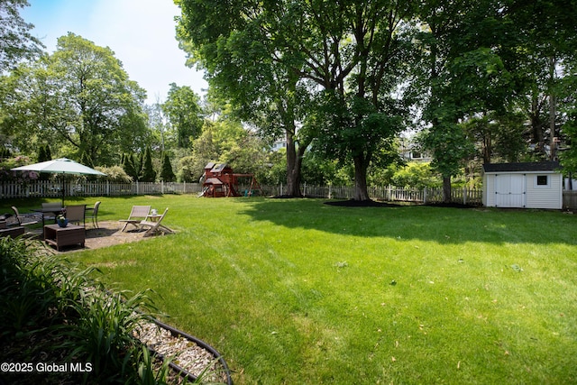 1269 Hawthorn Rd, Niskayuna, NY 12309 - fenced backyard with a playground, a storage shed, and a patio area
