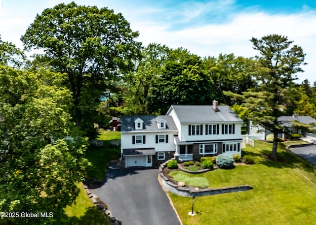 1269 Hawthorn Rd, Niskayuna, NY 12309 - view of front of home with a garage, asphalt driveway, a front lawn, and a chimney