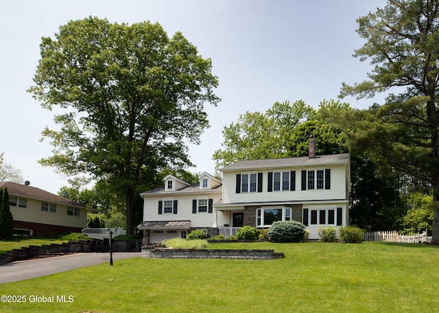 1269 Hawthorn Rd, Niskayuna, NY 12309 - view of front facade featuring stone siding, a chimney, and driveway