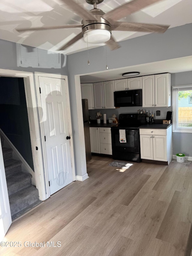 3516 Consaul Rd, Schenectady, NY 12304 - kitchen featuring black appliances, dark countertops, light wood-style flooring, and a ceiling fan