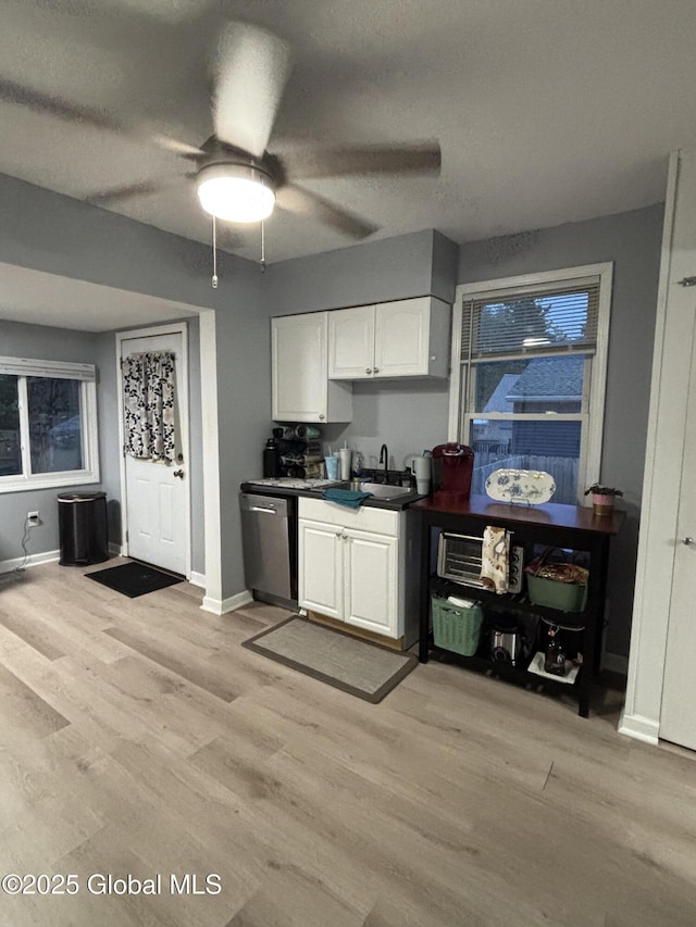3516 Consaul Rd, Schenectady, NY 12304 - kitchen featuring dishwasher, white cabinetry, ceiling fan, and light wood-style flooring