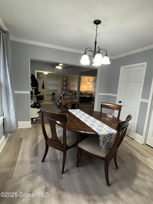 3516 Consaul Rd, Schenectady, NY 12304 - dining room with wood finished floors, crown molding, a chandelier, and baseboards