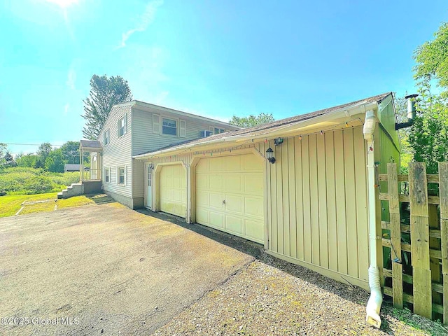 6770 Obrien Rd, Rome, NY 13440 - view of home's exterior with board and batten siding, a garage, and driveway