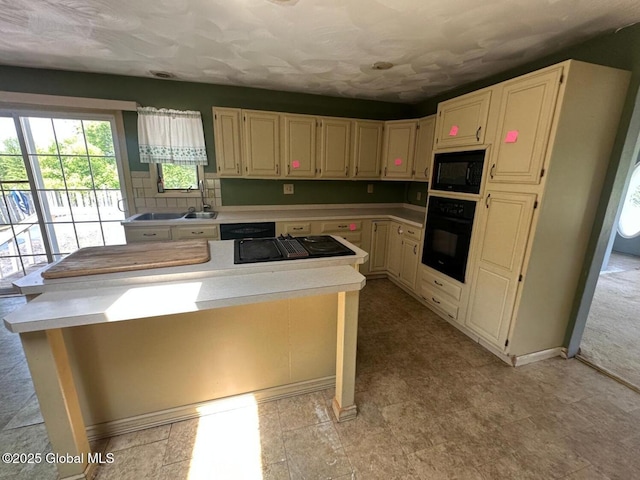 6770 Obrien Rd, Rome, NY 13440 - kitchen with black appliances, light countertops, a kitchen island, and a sink