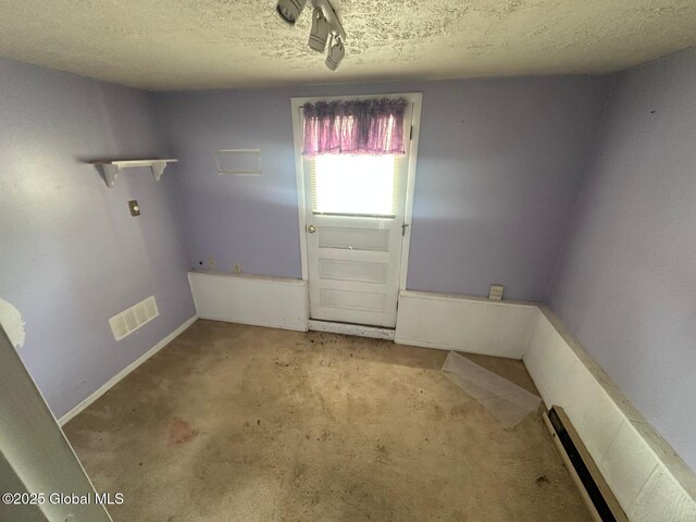 6770 Obrien Rd, Rome, NY 13440 - laundry area featuring a textured ceiling, carpet floors, and baseboards