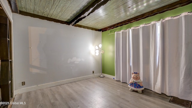 16 Caroline St, Amsterdam, NY 12010 - unfurnished room with wood ceiling, wood finished floors, and baseboards