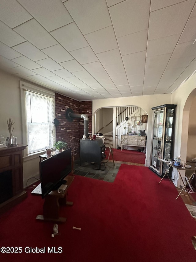 3226 Albany St, Schenectady, NY 12304 - interior space with a wood stove, arched walkways, and carpet