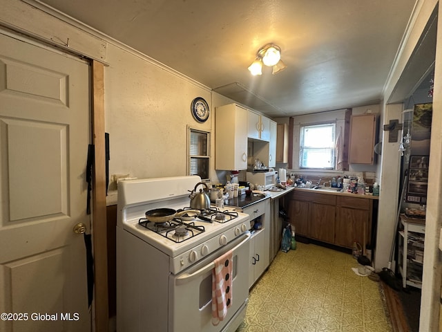3226 Albany St, Schenectady, NY 12304 - kitchen with white gas range oven and light floors