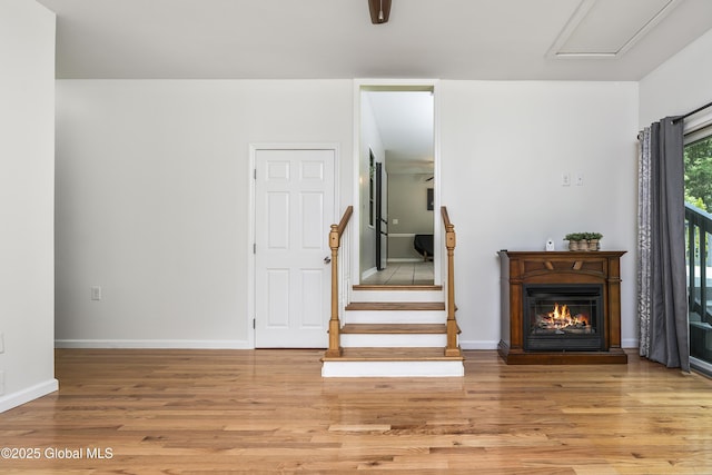 44 St Jude Ln, Glenville, NY 12302 - living area with light wood finished floors, a glass covered fireplace, and baseboards