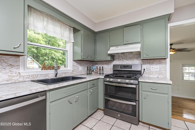 44 St Jude Ln, Glenville, NY 12302 - kitchen with under cabinet range hood, stainless steel appliances, a sink, and light countertops