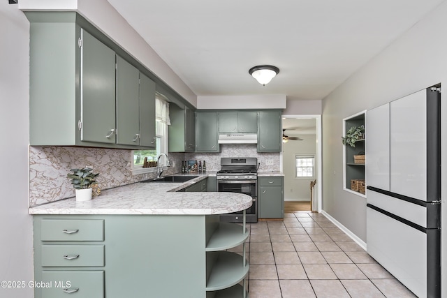 44 St Jude Ln, Glenville, NY 12302 - kitchen with stainless steel gas range oven, under cabinet range hood, a sink, freestanding refrigerator, and open shelves