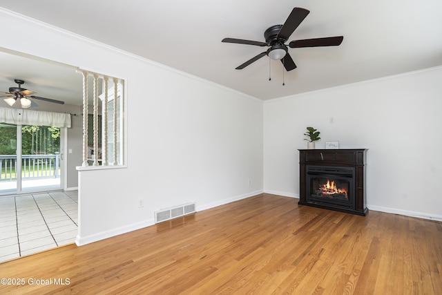 44 St Jude Ln, Glenville, NY 12302 - unfurnished living room with a ceiling fan, ornamental molding, a glass covered fireplace, wood finished floors, and baseboards