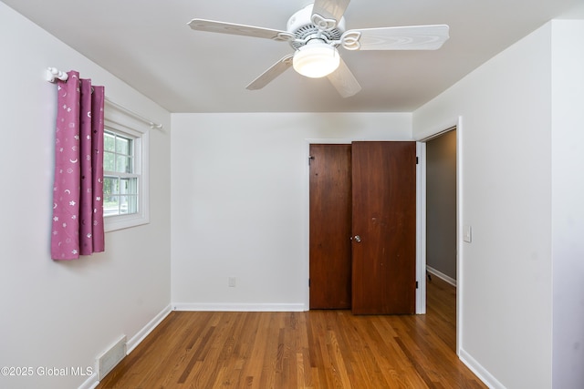 44 St Jude Ln, Glenville, NY 12302 - unfurnished bedroom with wood finished floors, baseboards, and ceiling fan