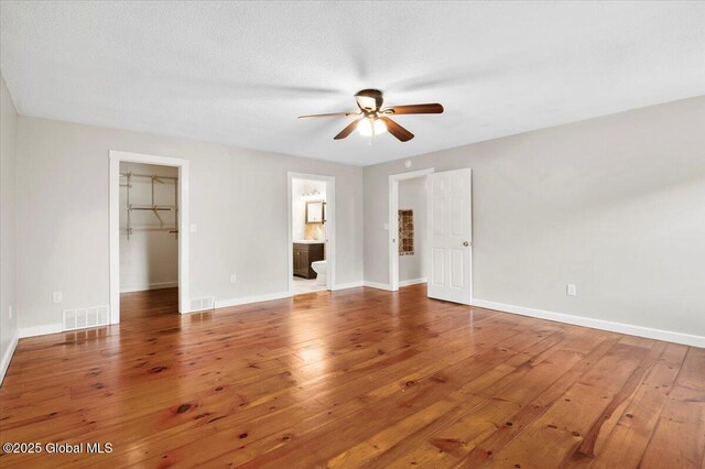 61 Lemaire Way, Argyle, NY 12809 - unfurnished bedroom featuring a walk in closet, hardwood / wood-style flooring, a closet, and ensuite bath