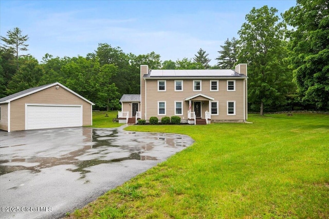 61 Lemaire Way, Argyle, NY 12809 - colonial house featuring a chimney, a detached garage, an outbuilding, roof mounted solar panels, and a front lawn