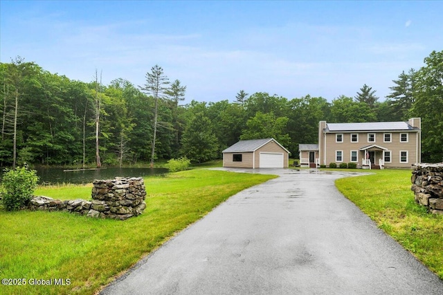 61 Lemaire Way, Argyle, NY 12809 - view of front of house featuring a detached garage, an outbuilding, a view of trees, and a front yard