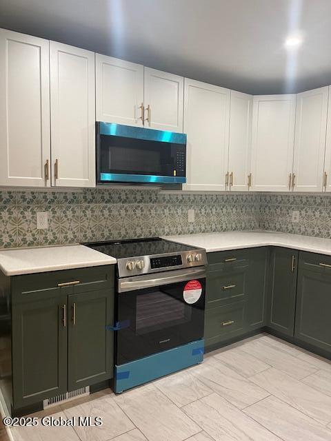 5 Hillandale Dr, Charlton, NY 12019 - kitchen featuring electric stove, light countertops, and white cabinetry