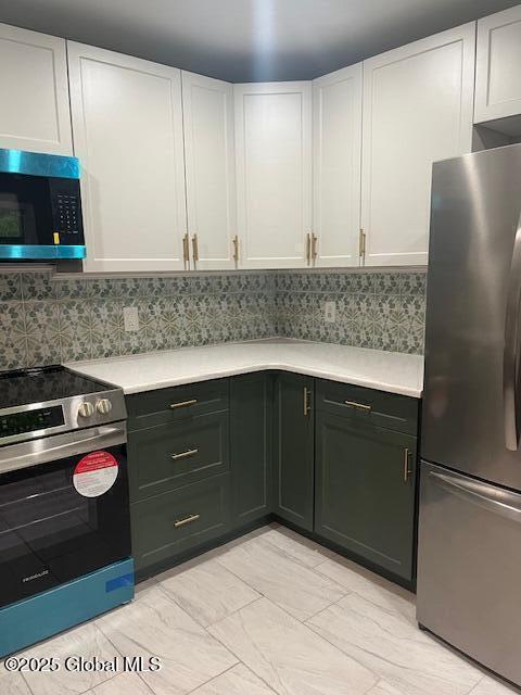 5 Hillandale Dr, Charlton, NY 12019 - kitchen featuring stainless steel appliances, light countertops, white cabinets, and backsplash