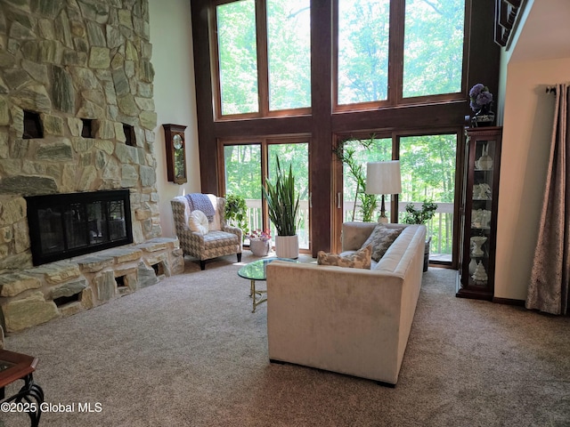 251 Vernon Rd, Glenville, NY 12302 - carpeted living room featuring plenty of natural light, a stone fireplace, and a high ceiling