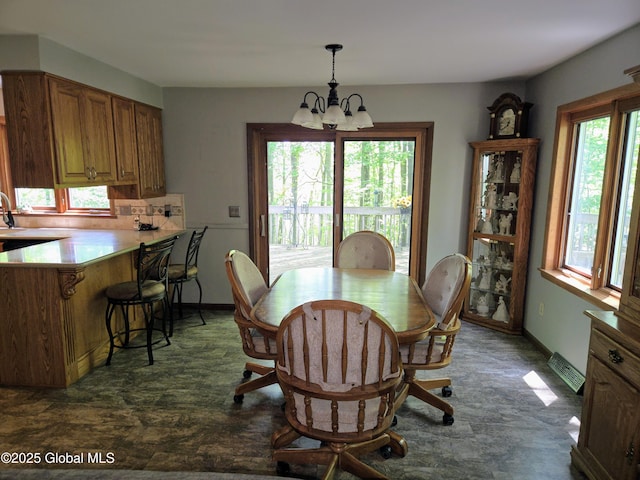 251 Vernon Rd, Glenville, NY 12302 - dining area featuring a chandelier and baseboards