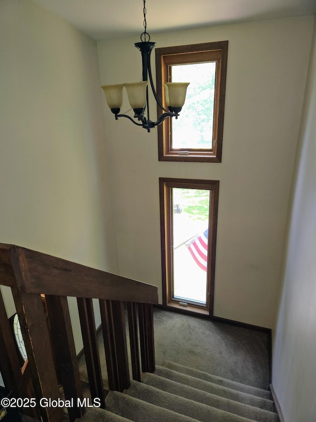 251 Vernon Rd, Glenville, NY 12302 - staircase with a chandelier, healthy amount of natural light, and carpet