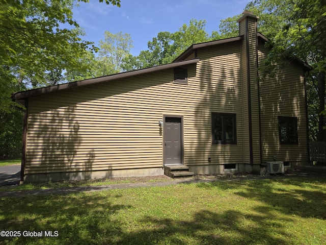 251 Vernon Rd, Glenville, NY 12302 - back of house featuring entry steps, a lawn, a chimney, and a cooling unit