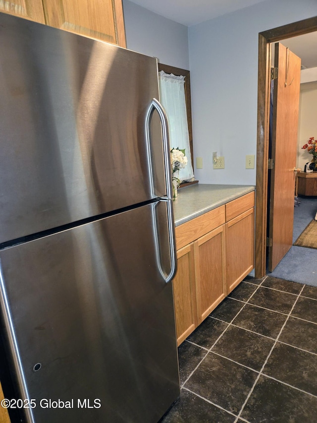 251 Vernon Rd, Glenville, NY 12302 - kitchen with freestanding refrigerator, light countertops, and brown cabinets