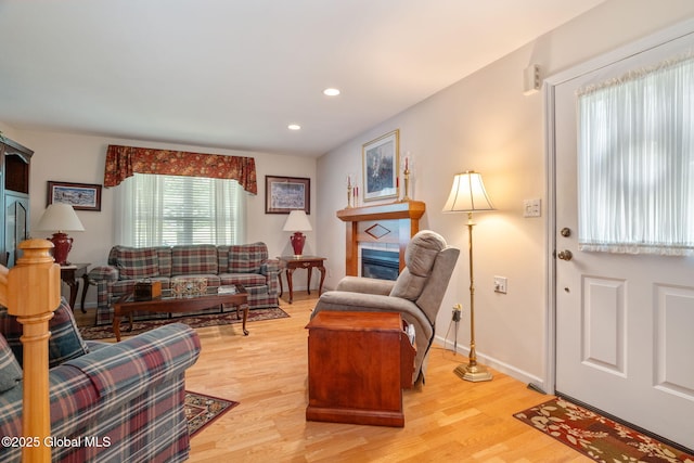 1401 Balltown Rd, Niskayuna, NY 12309 - living room with light wood-type flooring, a tile fireplace, recessed lighting, and baseboards