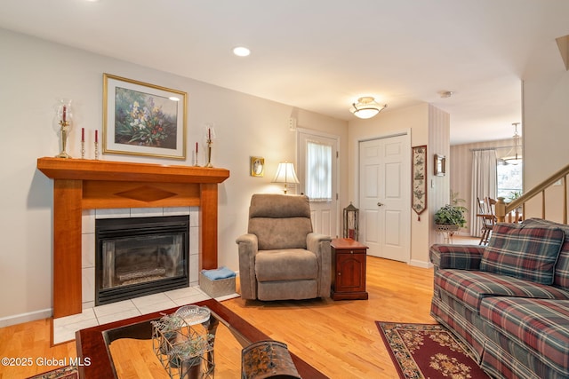 1401 Balltown Rd, Niskayuna, NY 12309 - living room with a fireplace, light wood-style floors, baseboards, stairway, and recessed lighting