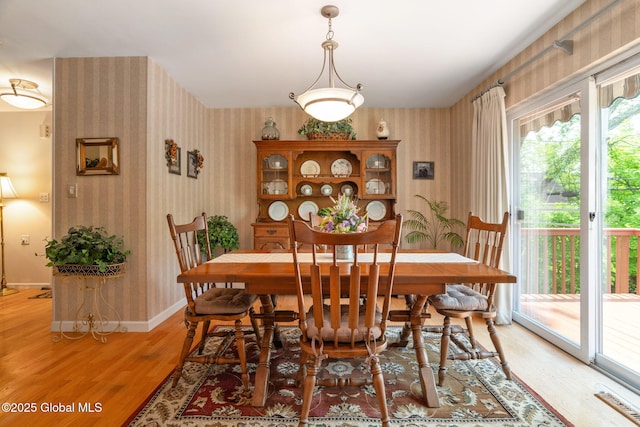 1401 Balltown Rd, Niskayuna, NY 12309 - dining space with wallpapered walls, light wood-style floors, and baseboards