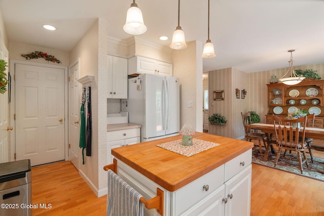 1401 Balltown Rd, Niskayuna, NY 12309 - kitchen with freestanding refrigerator, wallpapered walls, light wood finished floors, wooden counters, and white cabinets