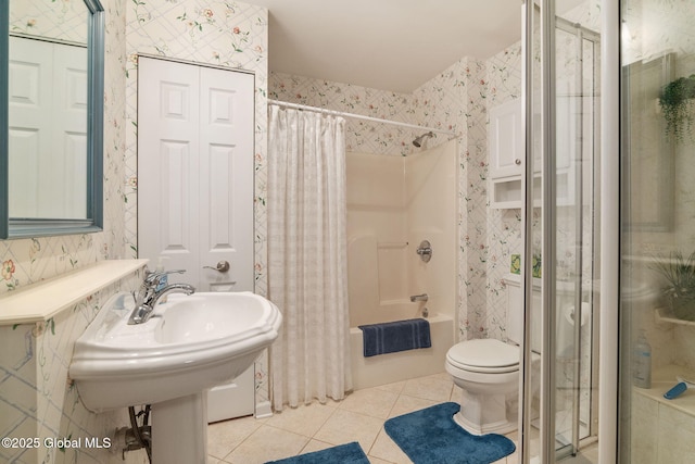 1401 Balltown Rd, Niskayuna, NY 12309 - full bath with wallpapered walls, tile patterned floors, shower / tub combo, and toilet