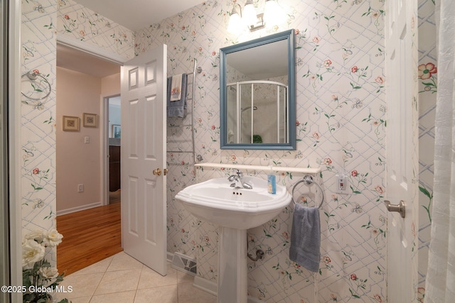 1401 Balltown Rd, Niskayuna, NY 12309 - bathroom featuring tile patterned floors, a stall shower, wallpapered walls, and baseboards
