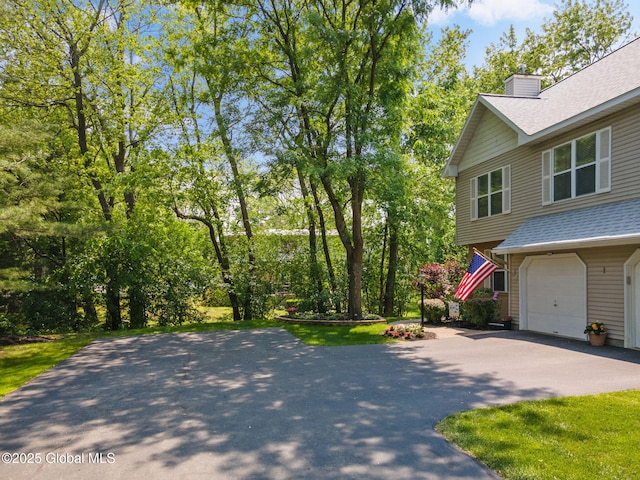1401 Balltown Rd, Niskayuna, NY 12309 - view of property exterior with driveway, a chimney, roof with shingles, and a garage