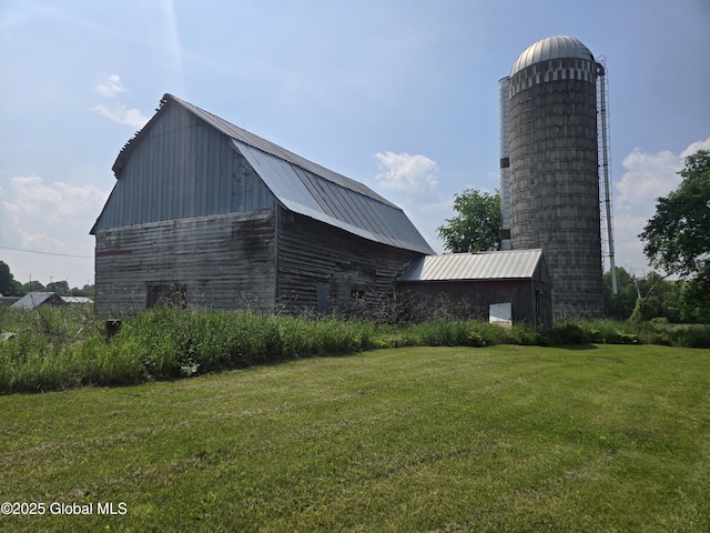 1056 Carlisle Rd, Root, NY 13317 - view of side of property with a barn, a lawn, metal roof, and an outbuilding