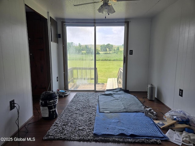 1056 Carlisle Rd, Root, NY 13317 - bedroom featuring access to exterior, multiple windows, wood finished floors, wooden walls, and a textured ceiling