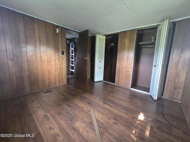 1056 Carlisle Rd, Root, NY 13317 - unfurnished bedroom featuring hardwood / wood-style flooring and wooden walls