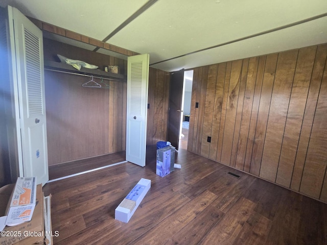 1056 Carlisle Rd, Root, NY 13317 - unfurnished bedroom with wood finished floors, wooden walls, and a closet