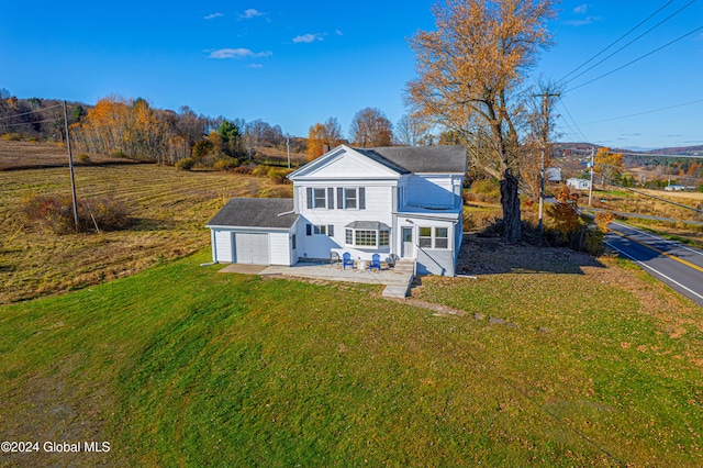 1176 State Highway 41, Afton, NY 13730 - view of front of house featuring a patio, a front lawn, a garage, and roof with shingles