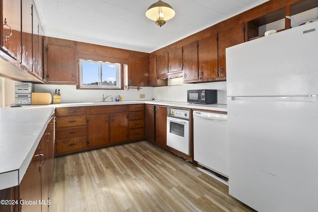 1176 State Highway 41, Afton, NY 13730 - kitchen with white appliances, light wood-type flooring, a sink, light countertops, and brown cabinetry