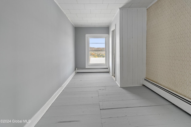 1176 State Highway 41, Afton, NY 13730 - corridor with a baseboard heating unit, hardwood / wood-style flooring, baseboards, ornamental molding, and wallpapered walls