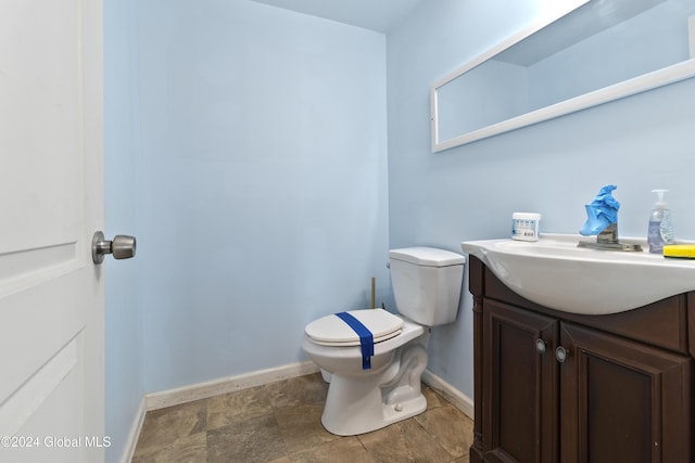 1176 State Highway 41, Afton, NY 13730 - half bath with vanity, toilet, baseboards, and stone finish flooring